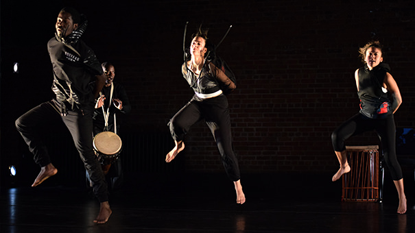 Dance students perform accompanied by students playing drums.