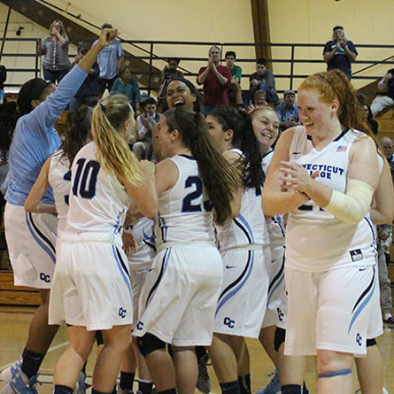 The women's basketball team celebrates their recent 61-55 home victory over nationally ranked Tufts, improving their record to 8-0.