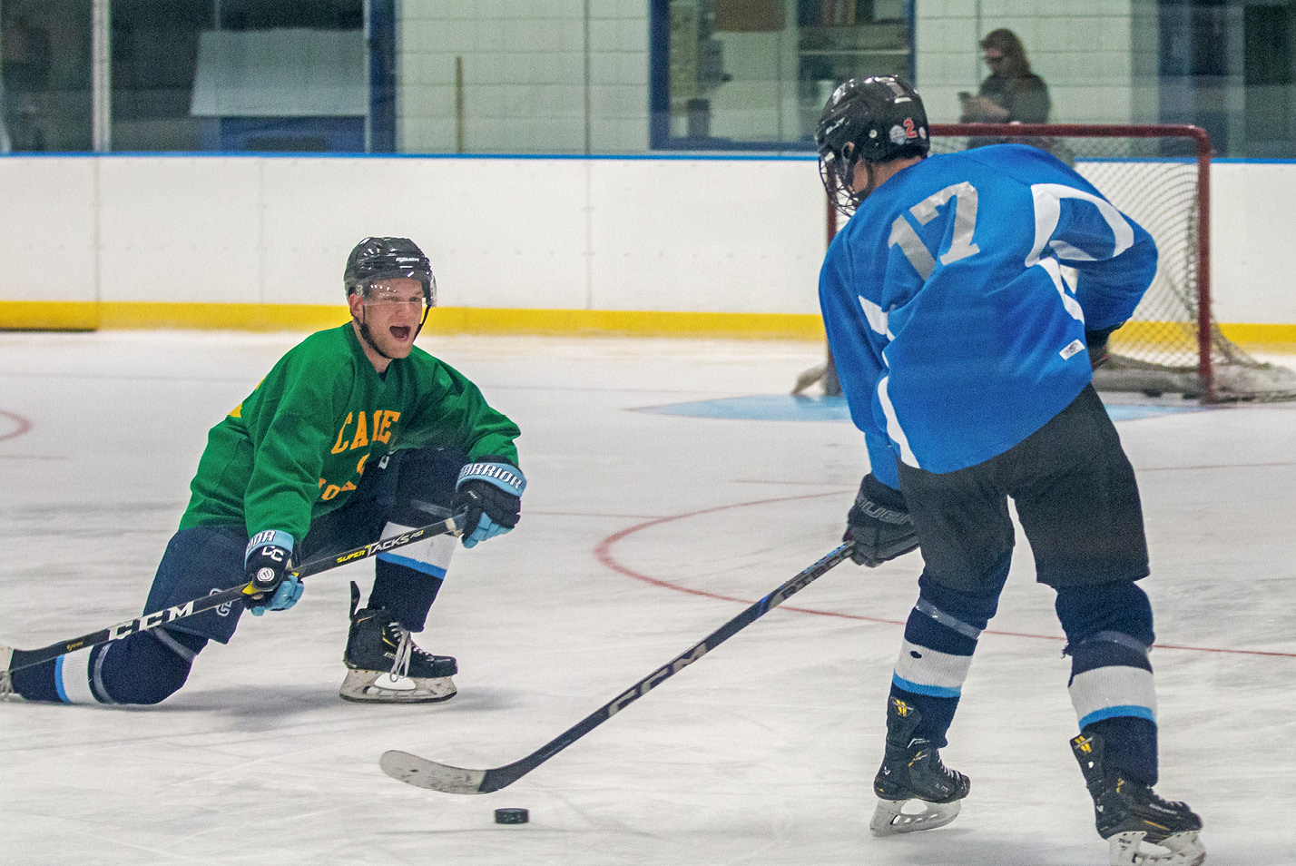 Two players face off during an alumni hockey event at Fall Weekend 2024