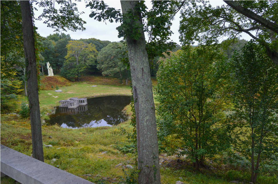 A photo of the view from the porch of the Glass House. Overlooks a pond, pavilion, and additional green space