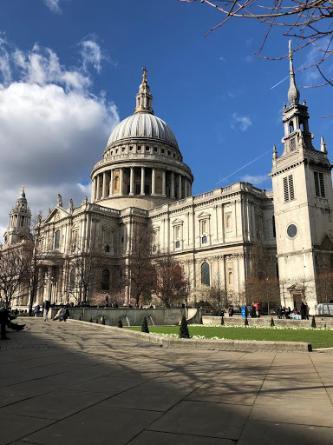 A photo of Saint Paul’s Cathedral in London showing an impressive facade, including a large domed roof with a cross at its top.  
