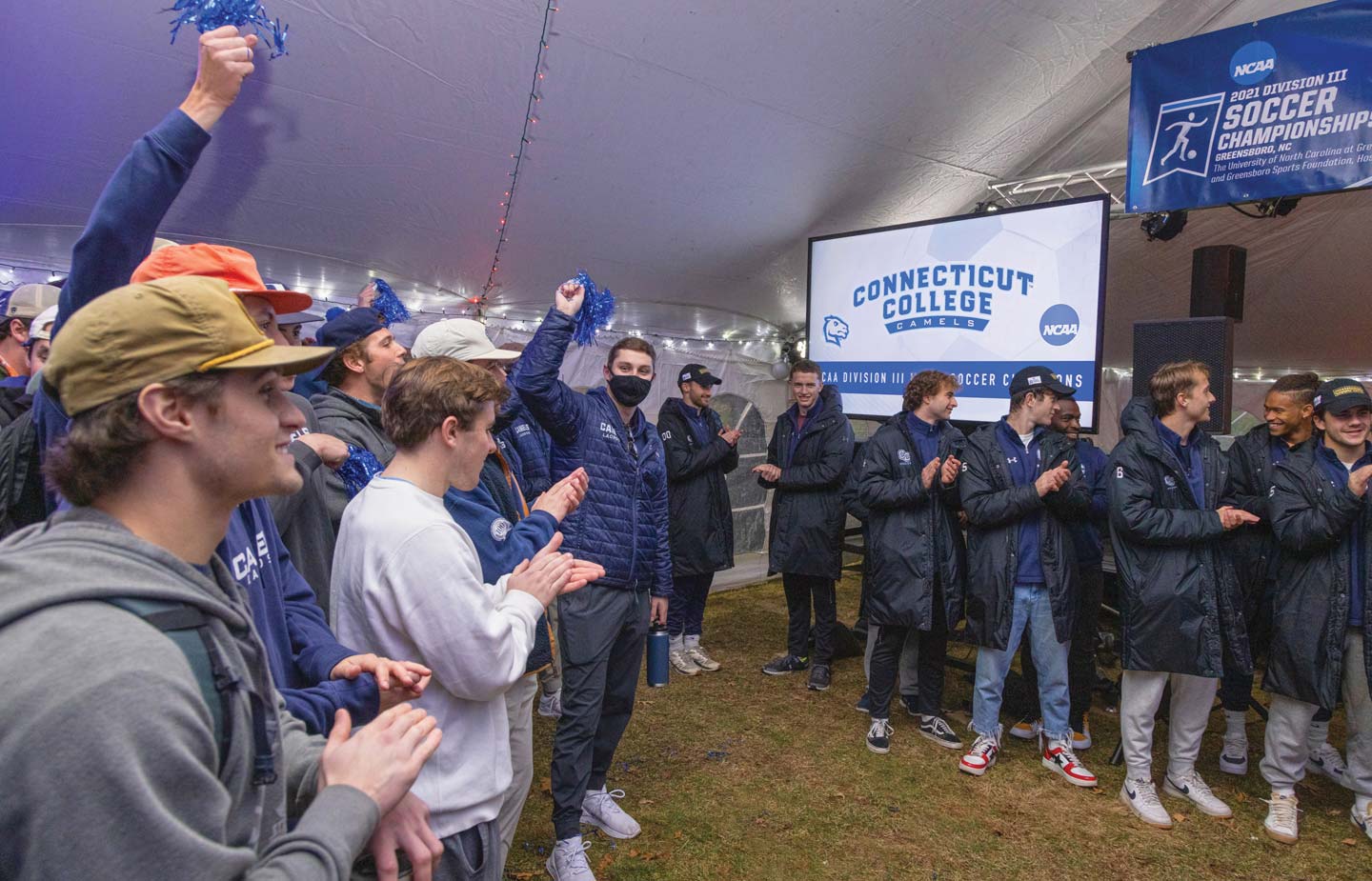 Image of soccer pep rally under tent on Tempel Green