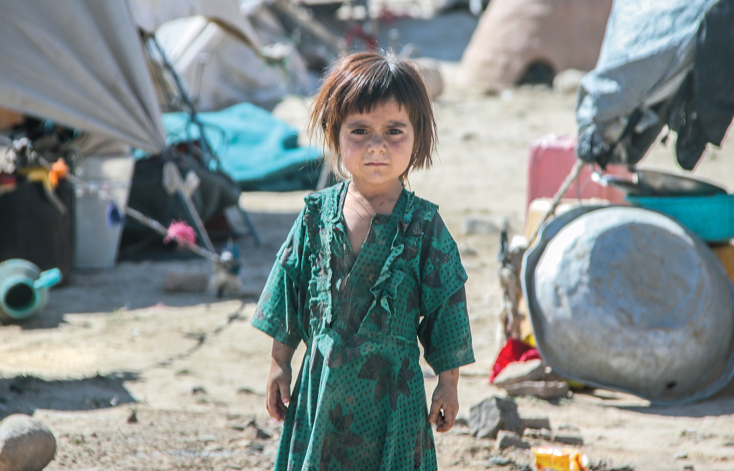 Child on desolate landscape in Afghanistan