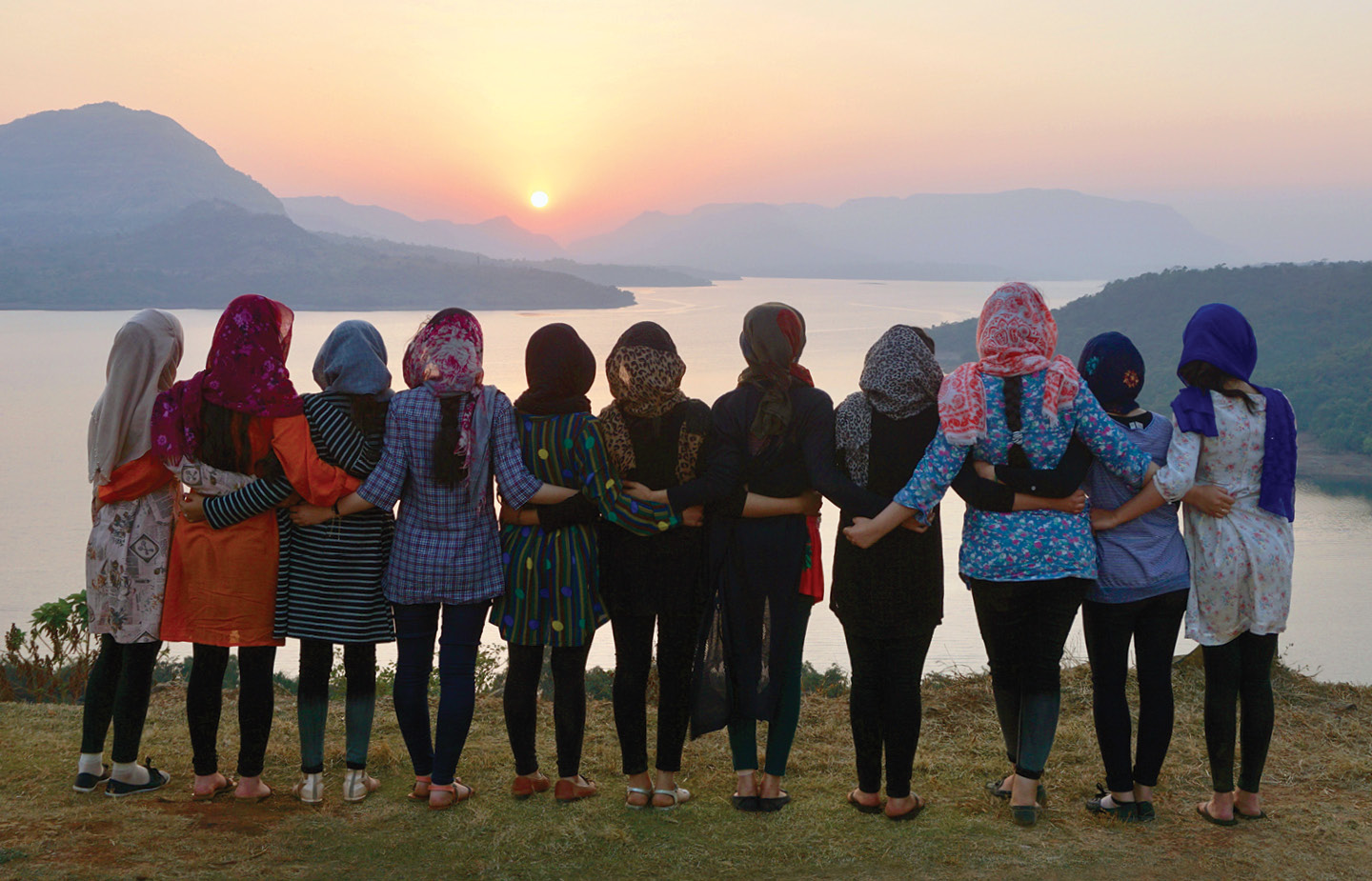 afghan students looking at sunset in distance