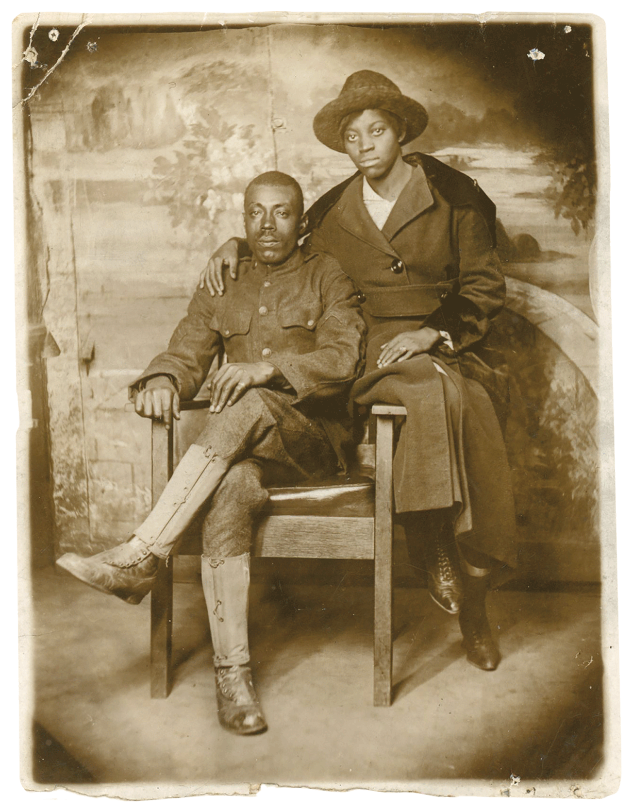 Historic image of early 20th century couple, man in uniform seated