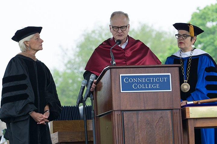 President Bergeron and DeFred G. Folts III present Pam Zilly '75 with the college medal.