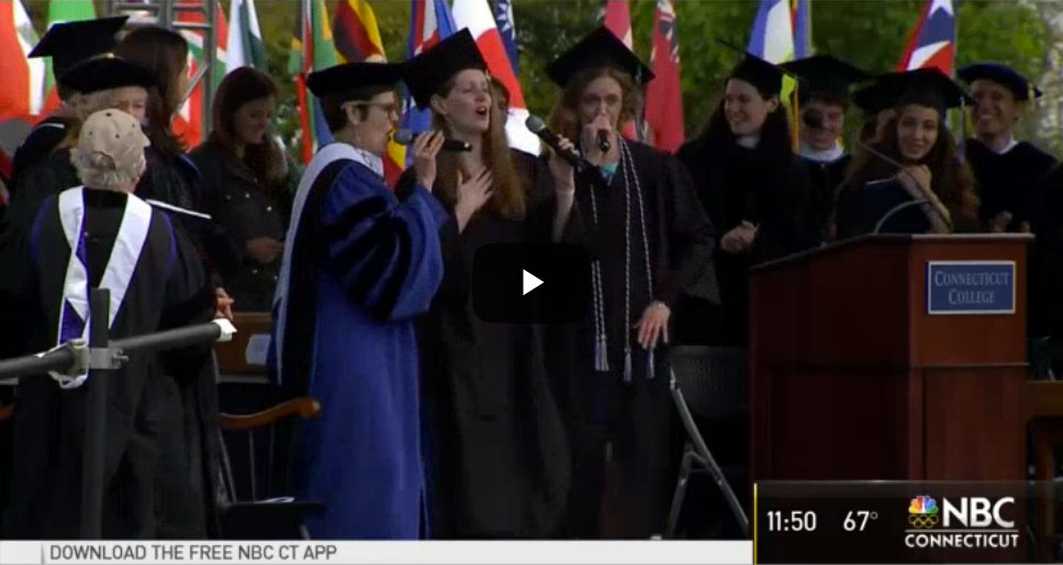 Screenshot from video. Katherine Bergeron performs the Alma Mater Remix with students at Commencement.