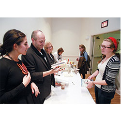Jenny Morrissey '18, right, has her books signed by authors Colum McCann and Jessica Soffer ’07. McCann and Soffer were on campus to discuss their work and the process of writing as part of Connecticut College’s Daniel Klagsbrun Symposium on Creative Arts and Moral Vision.