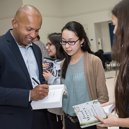 Bryan Stevenson chats with students as he signs copies of his book, 