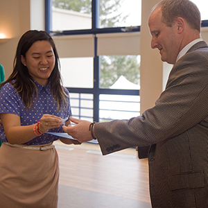 Nu Rho Psi inductee Tanya Songtachalert ’18 accepts her certificate and pin from Associate Professor of Psychology Joseph Schroeder at the induction ceremony May 2.