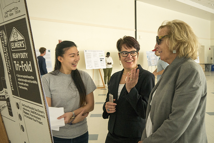 President Katherine Bergeron talks with a student about her research. 