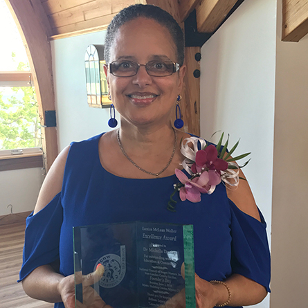 Professor Michelle Dunlap poses with award she just won