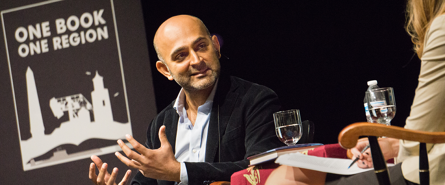 Author Mohsin Hamid speaks on stage at Connecticut College