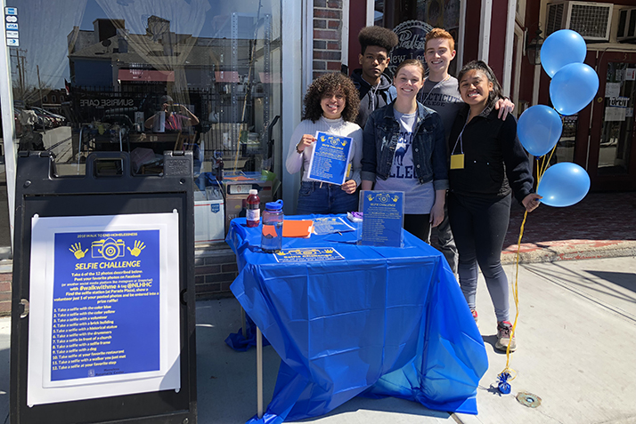Christina Cruz ’20, Yabsira Adera ’20, Holleran Center Program Coordinator Angela Barney, Ned Manus ’20 and Rosalinda Pineda ’20 encourage walkers to take selfies and post them to social media using #WalkWithMe to raise awareness about the effort to end homelessness in New London. 