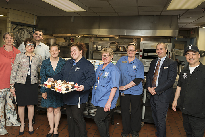 Members of the Catering Team pose for a photo with President Katherine Bergeron and others. 