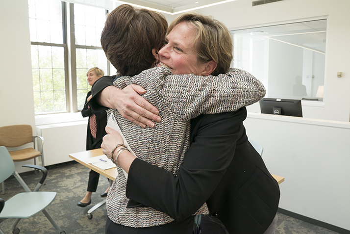 Melissa Ryan, assistant director of the Walter Commons, hugs President Katherine Bergeron after she is surprised with the Rising Star Award. 