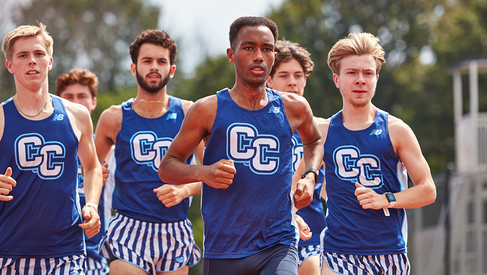 Members of the men's cross country team practice on the track. 