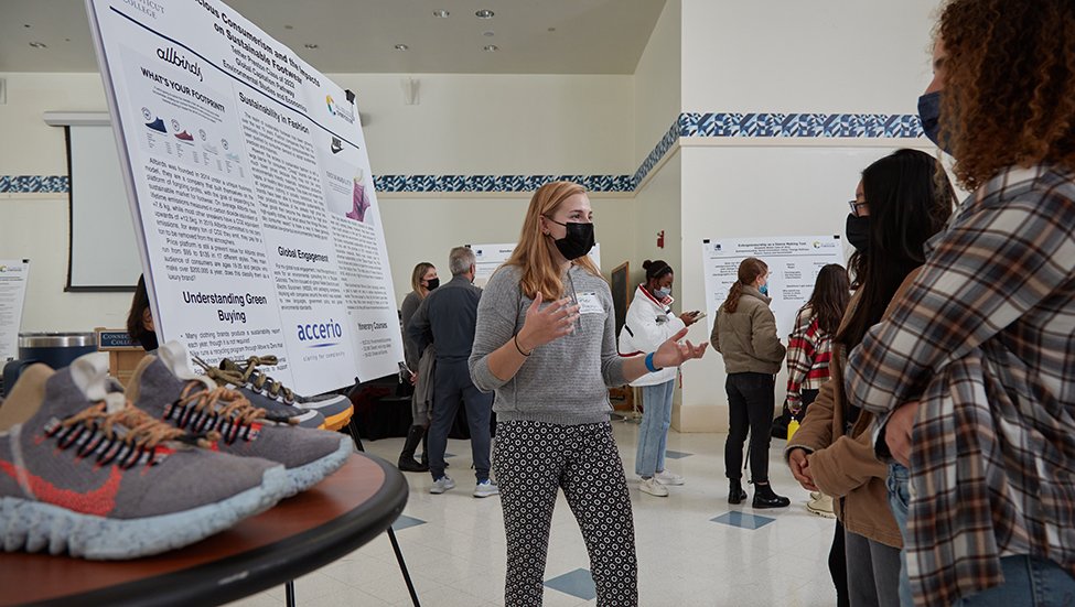 A student presents a poster at the ACS poster session. 