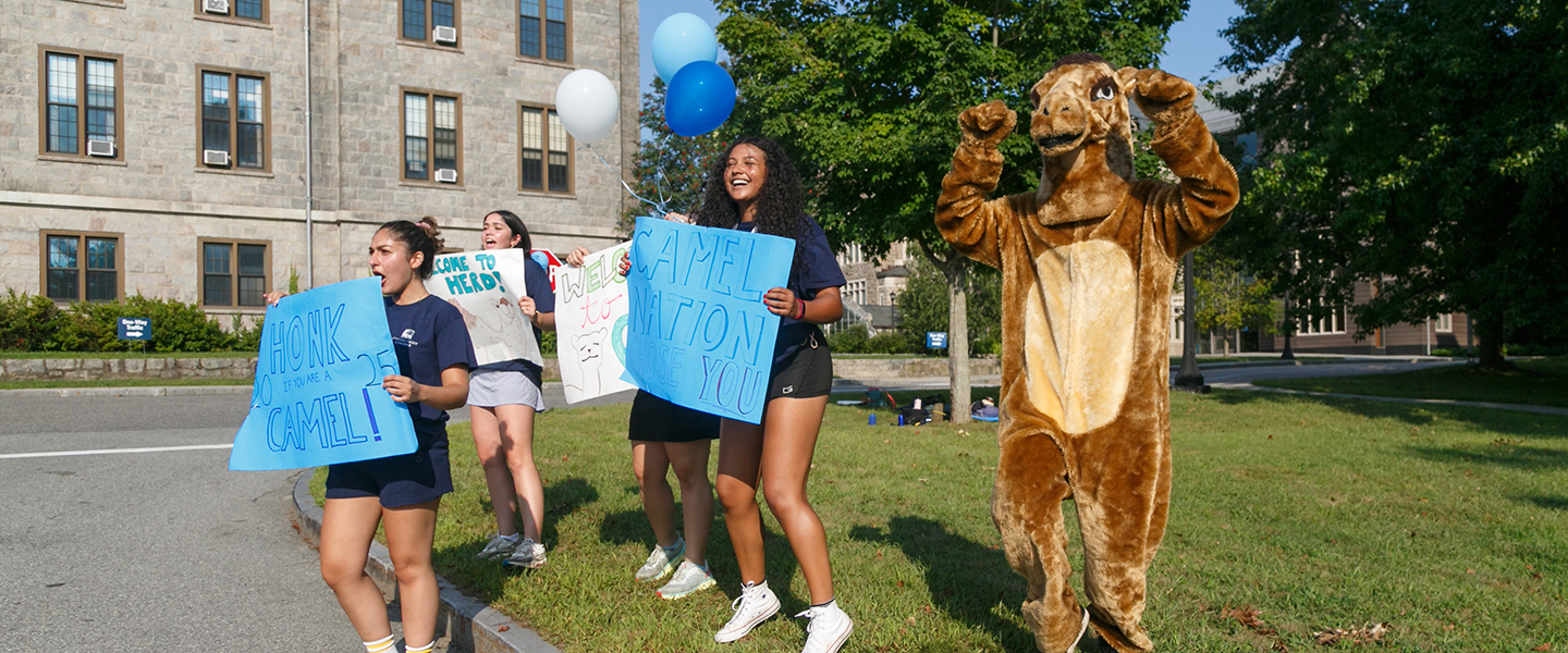 Students and the Camel mascot greet new students with cheers, balloons and colorful signs.