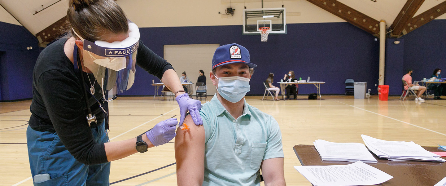 A student gets a COVID-19 vaccine on campus.