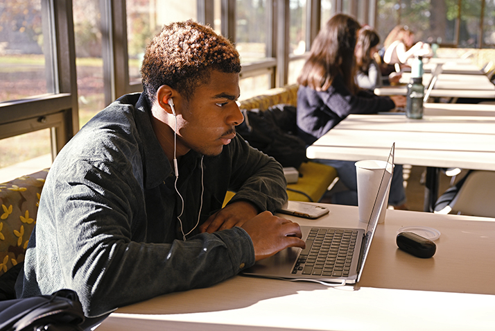 A student studies in a campus coffee shop.