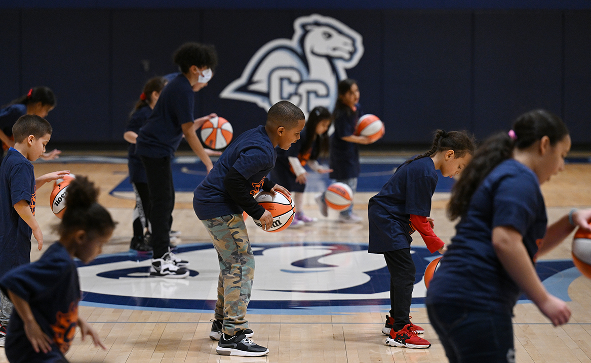 Children from the Salvation Army Boys and Girls Club of New London participate in a dribbling drill during a basketball skills clinic with the Connecticut Sun hosted by the Holleran Center for Community Action.