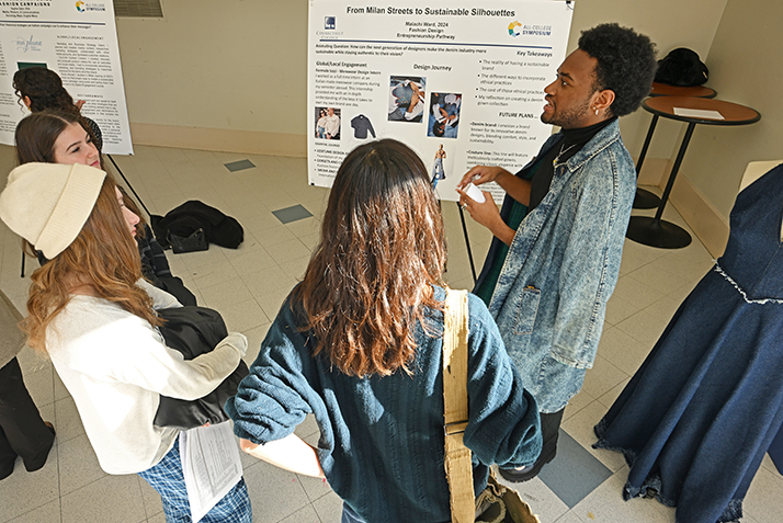Malachi Ward ’24 presents his poster, “From Milan Streets to Sustainable Silhouettes: A Fashion Designer’s Odyssey,” during the Entrepreneurship Pathway poster session in the 1962 Room.