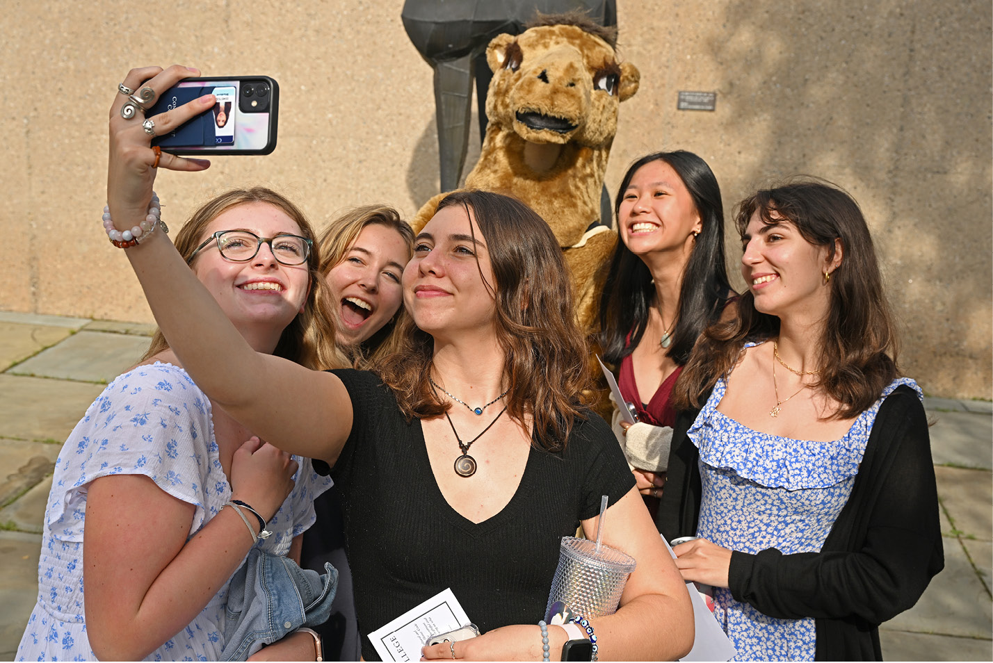 Students take a selfie with the camel mascot in Castle Court.