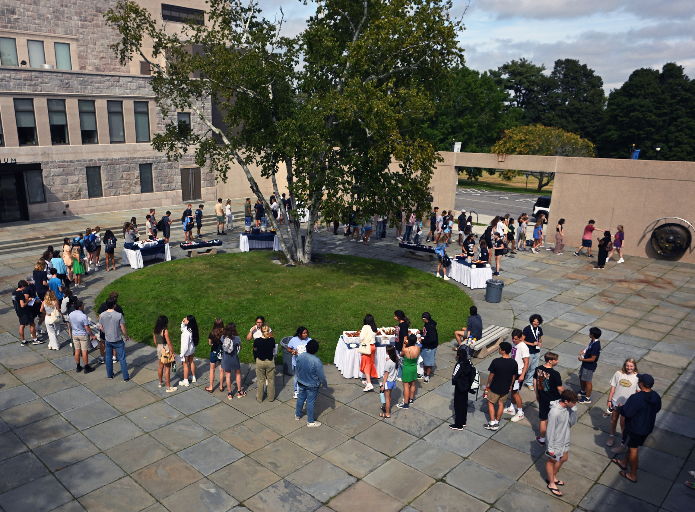 A wide shot of students lining up to ring the ceremonial gong in Castle Court.