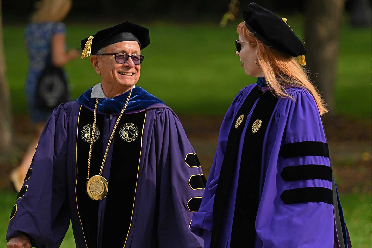 Interim President Wong walks with Dean of the Faculty Danielle Egan at Convocation