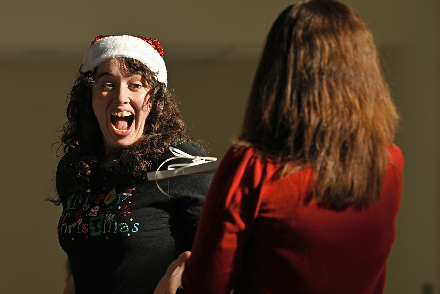 Staff member collecting a prize during the year-end holiday party.