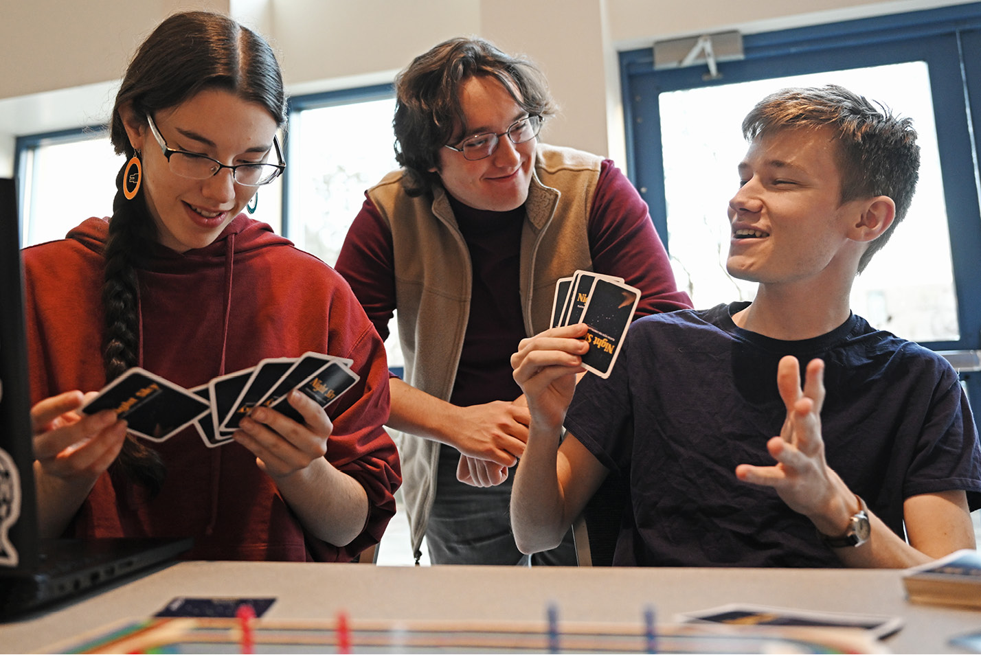 Gaming club members, from left, Beth Marsh ’24, Ian Rawlings ’25, and Alex Meyer ’25 play cribbage at their table during the Spring Student Involvement Fair.