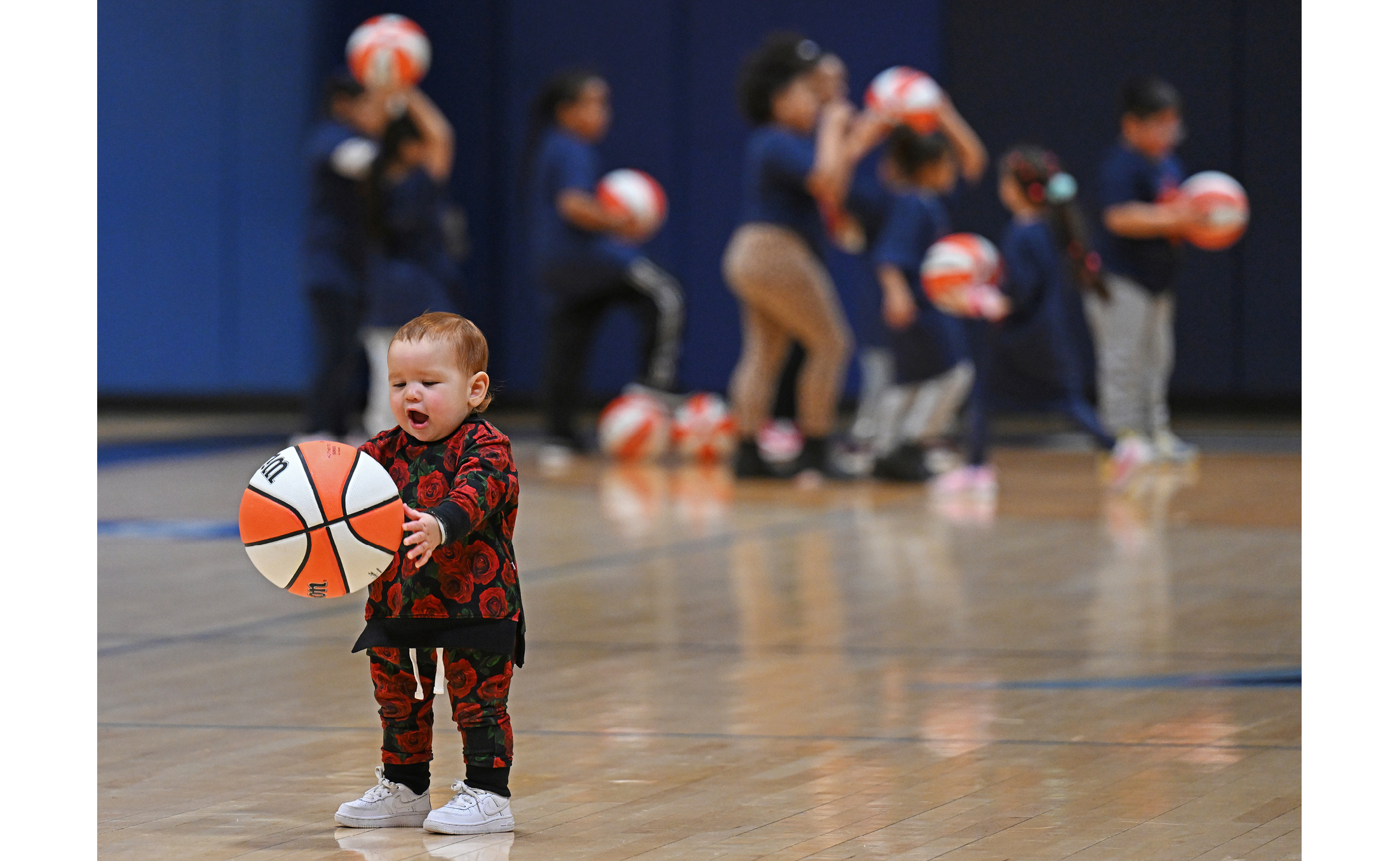 A child holds a basketball at a Salvation Army Boys and Girls Club of New London basketball clinic at Conn.