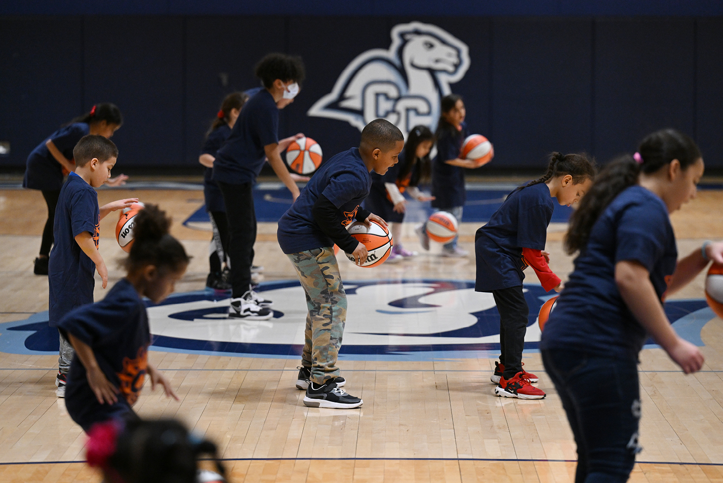 Children from the Salvation Army Boys and Girls Club of New London participate in a dribbling drill.