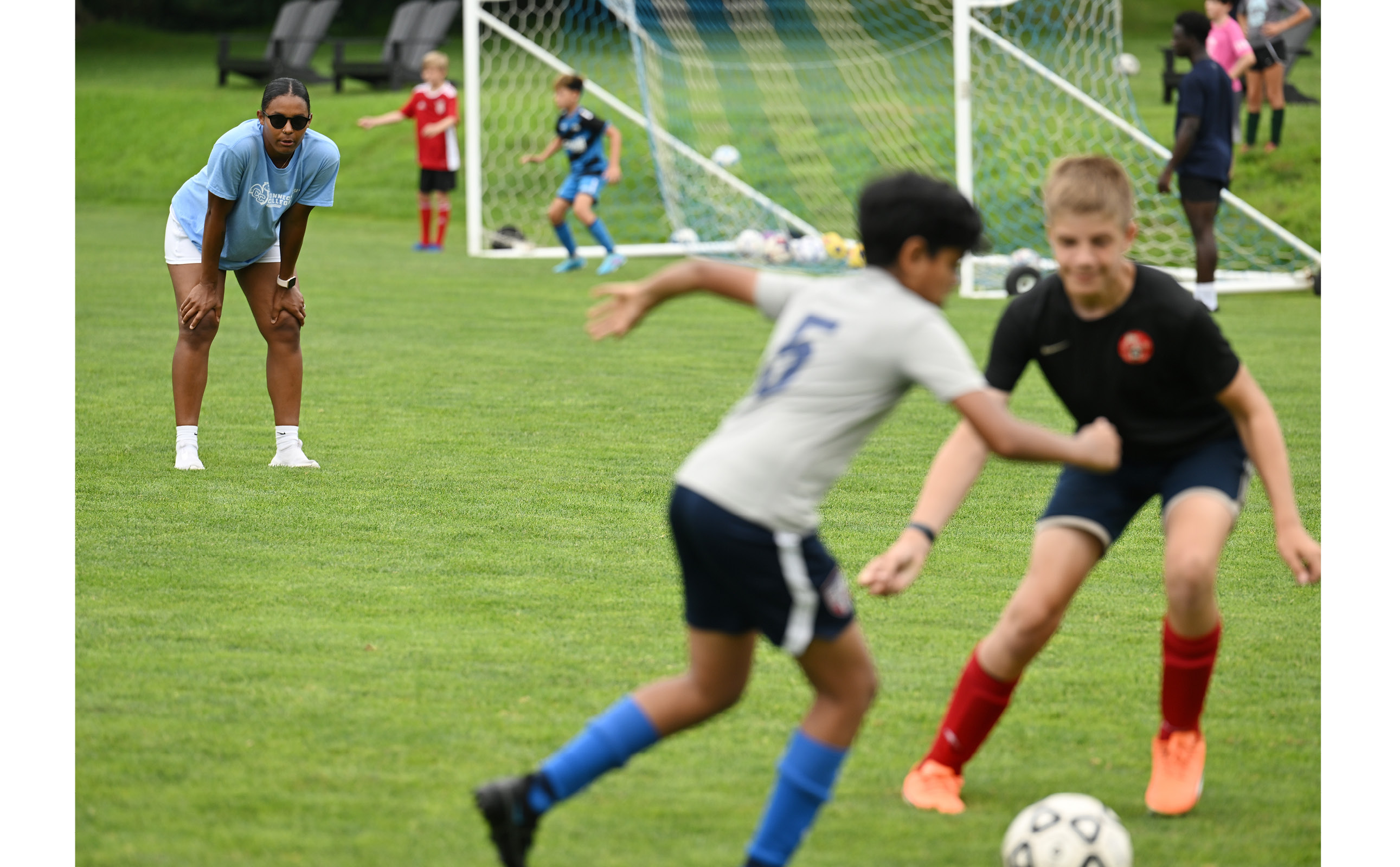 Connecticut College assistant women’s soccer coach Mia Santana leads soccer camp on Harkness Green. Conn's annual summer sports camps are popular in the region.