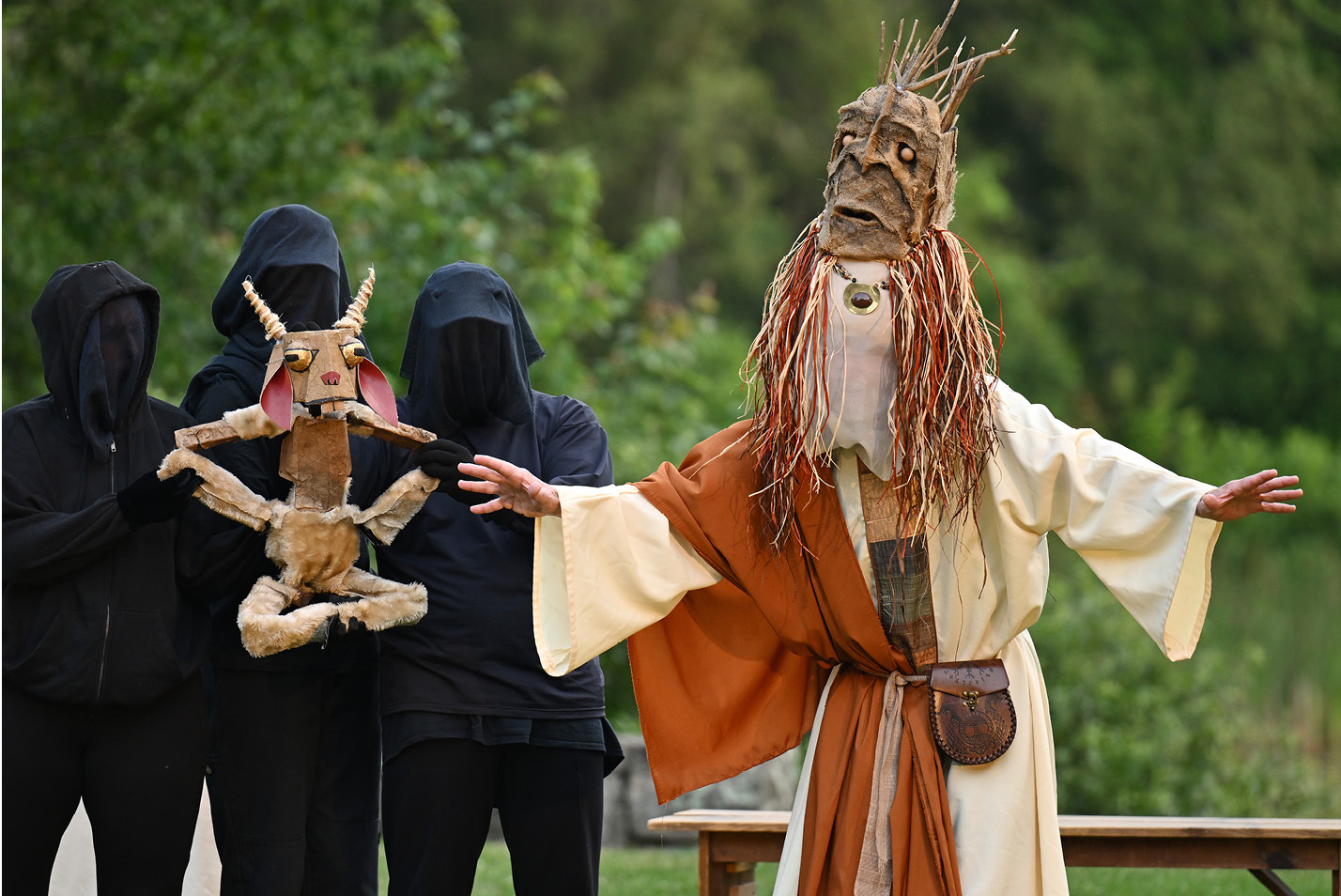 Masked actors perform during Flock Theater's Shakespeare in the Park in the Arboretum