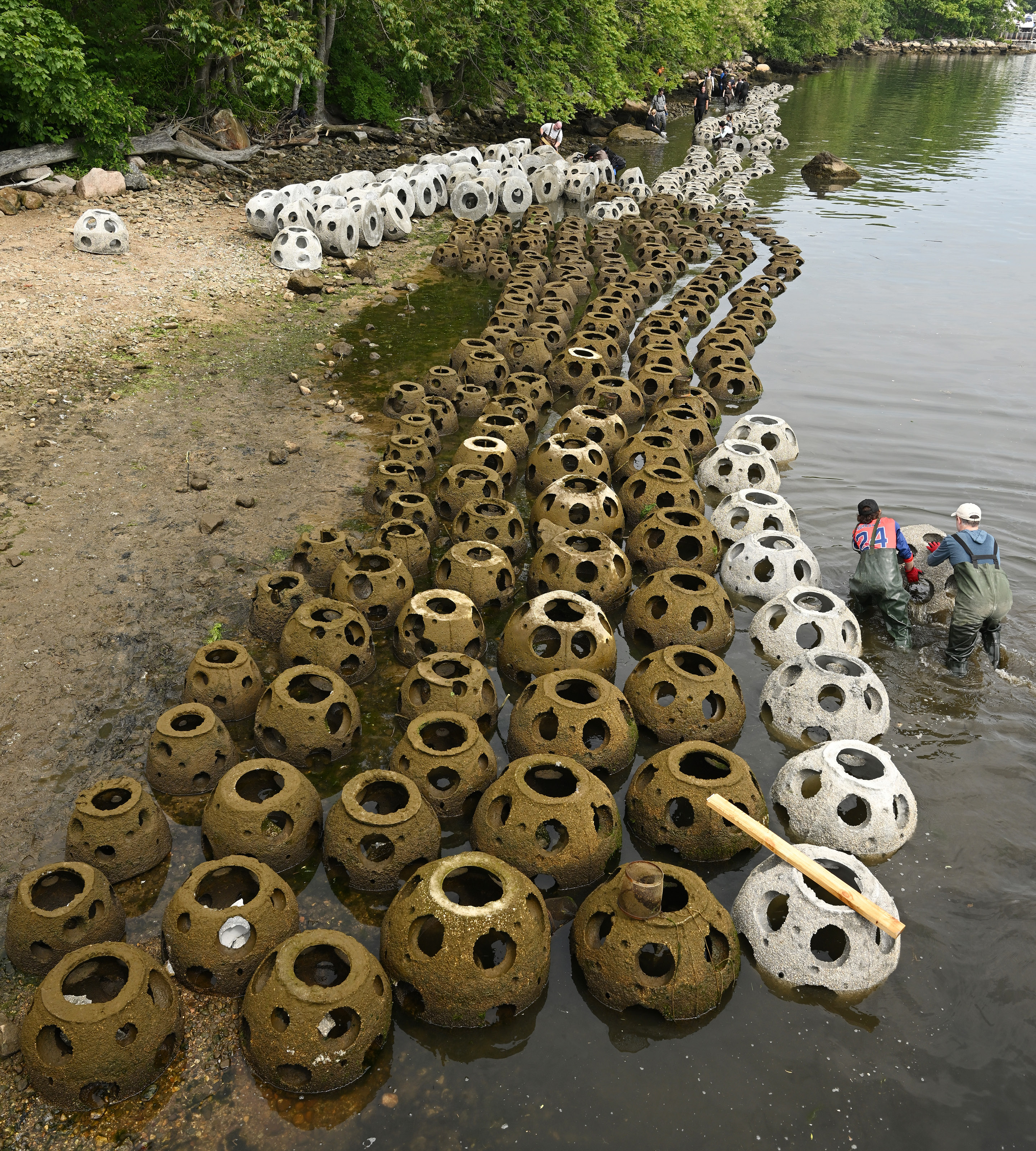 Bird's eye view of hundreds of reef balls ready for installation in the Thames River