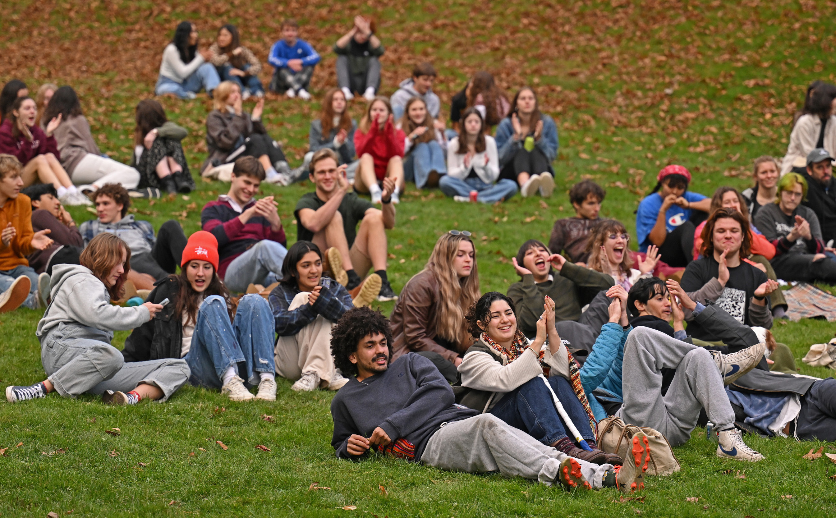 Students on the grass listening to live music