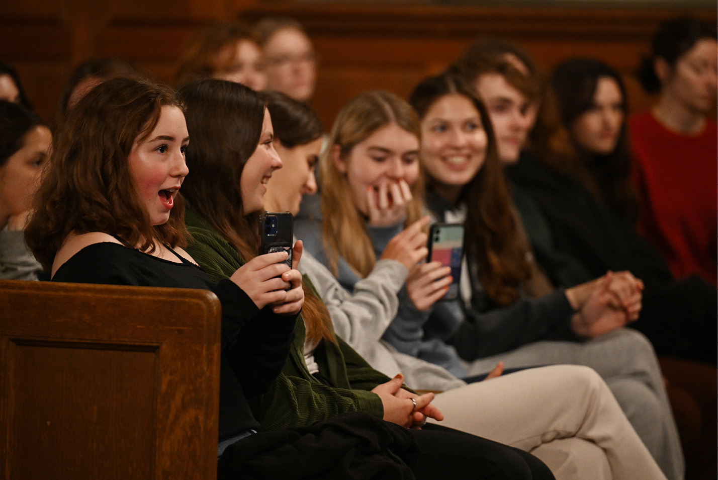 Crowd watches and films the Halloween a capella Battle of the Bands at Harkness Chapel.