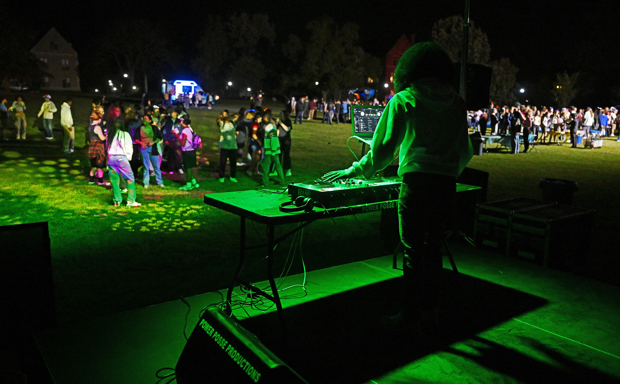 Students DJs at Fall carnival with crowd in background
