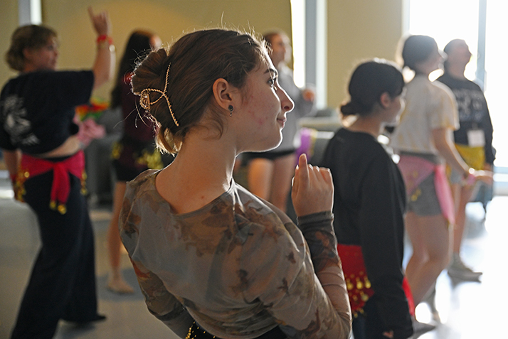 Participants in the Summer@Conn pre-college program practice belly dancing skills Monday, July 10, 2023 in Cro’s Nest. Summer@conn counselor Maged Hassan ’25 offered a presentation to the group on the history and culture of the art form before using a video tutorial to teach the basics.