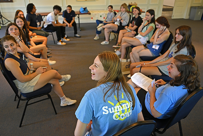 Victoria Edwards '25, center, and Meredith  Harper '24, both student counselors with the Summer@Conn pre-college program, laugh at a comment from  Director of Summer Programs Ashlyn Healy '20, during orientation