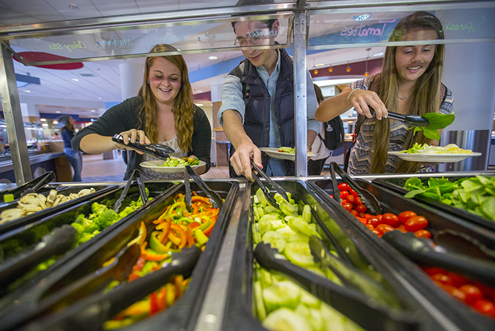 Students help themselves to a salad bar in the dining hall.