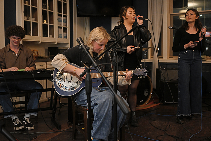 A student band performs at open mic night in a coffeehouse