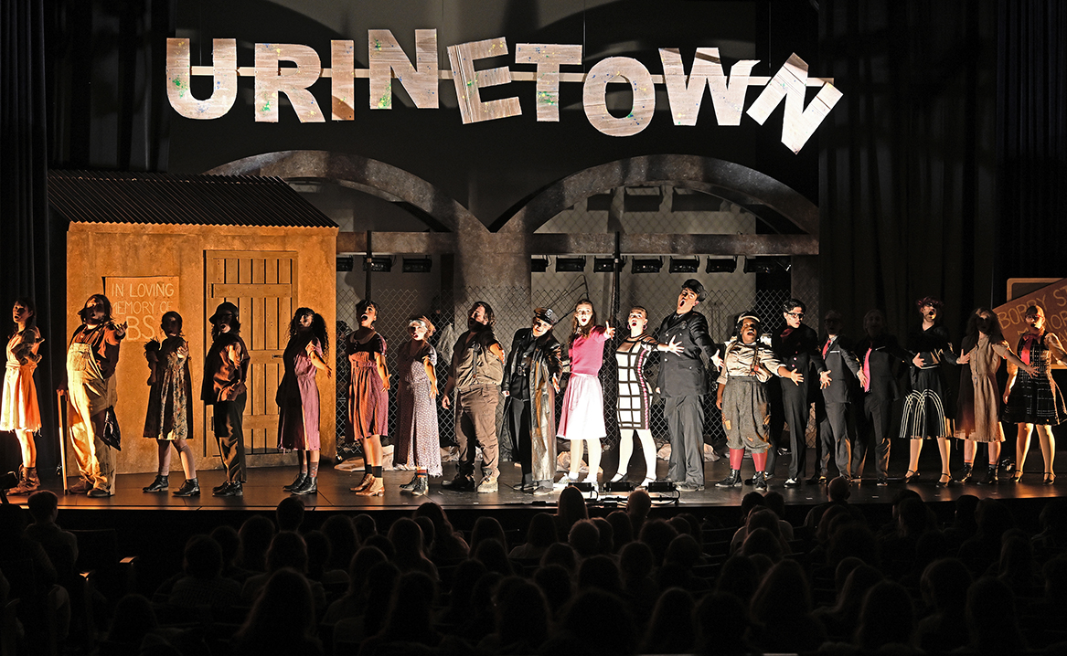 Actors on stage take a final bow at the curtain call