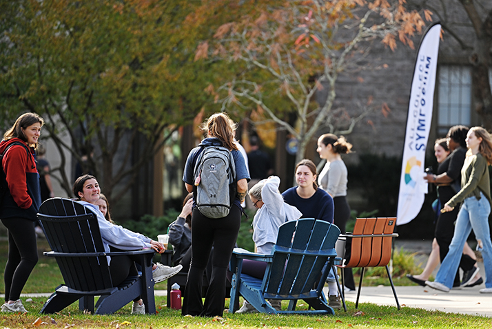 Students relax outside during the All-College Symposium.