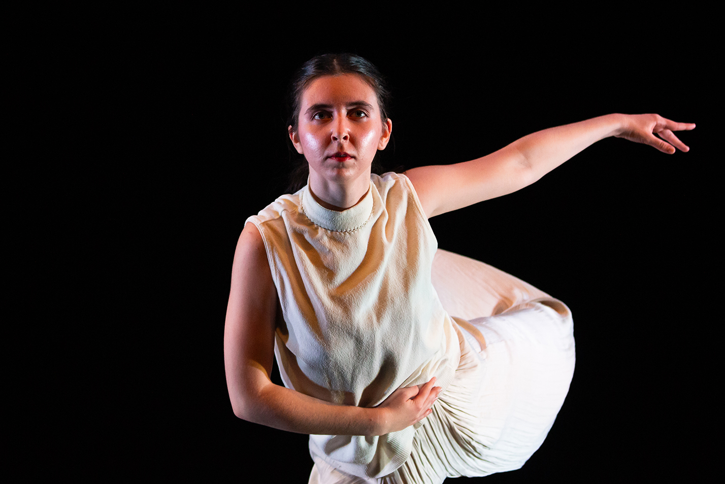 A student dancer strikes a pose during a performance.