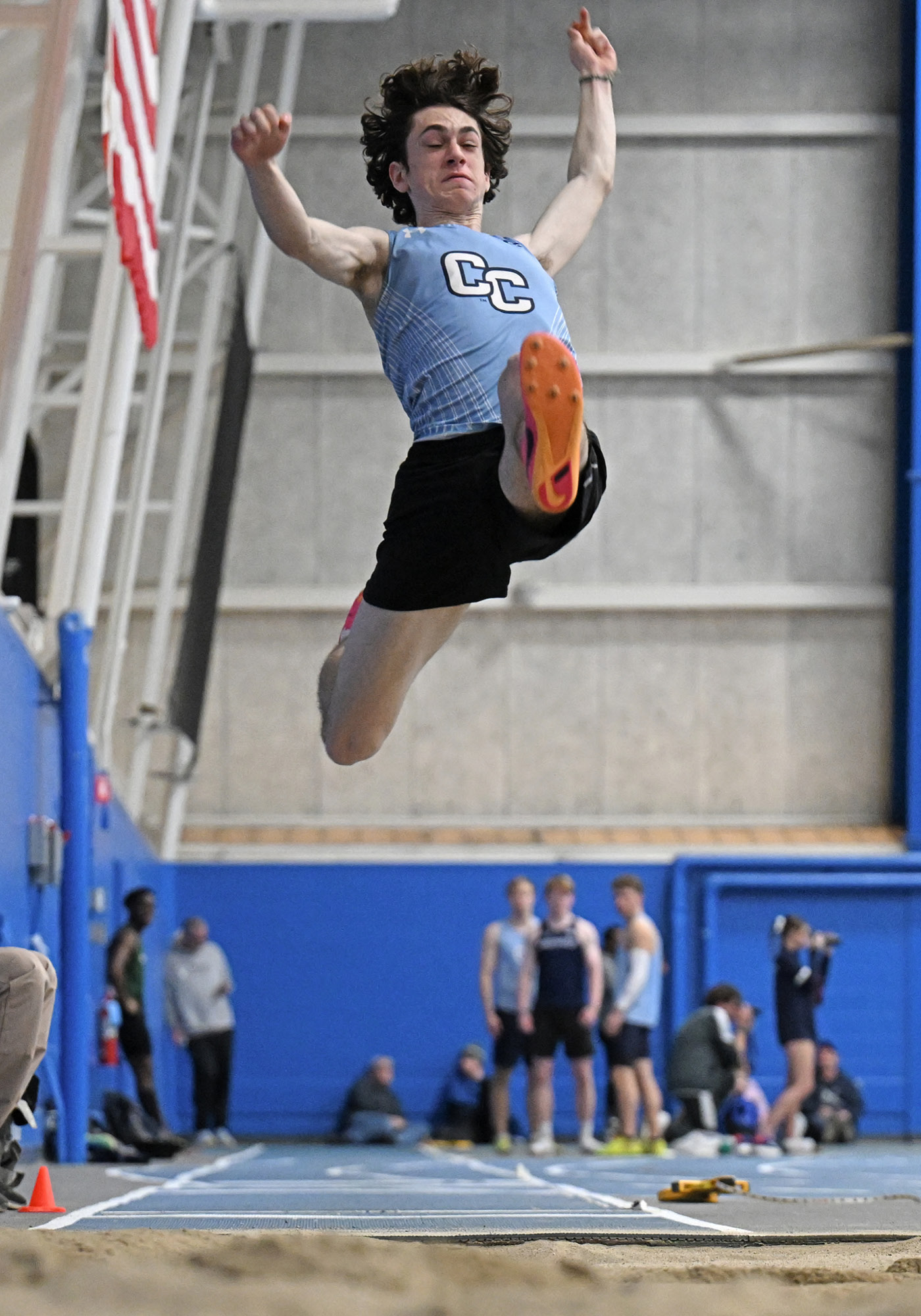 Errol Apostolopoulos ’27 leaps through the air at a track meet.