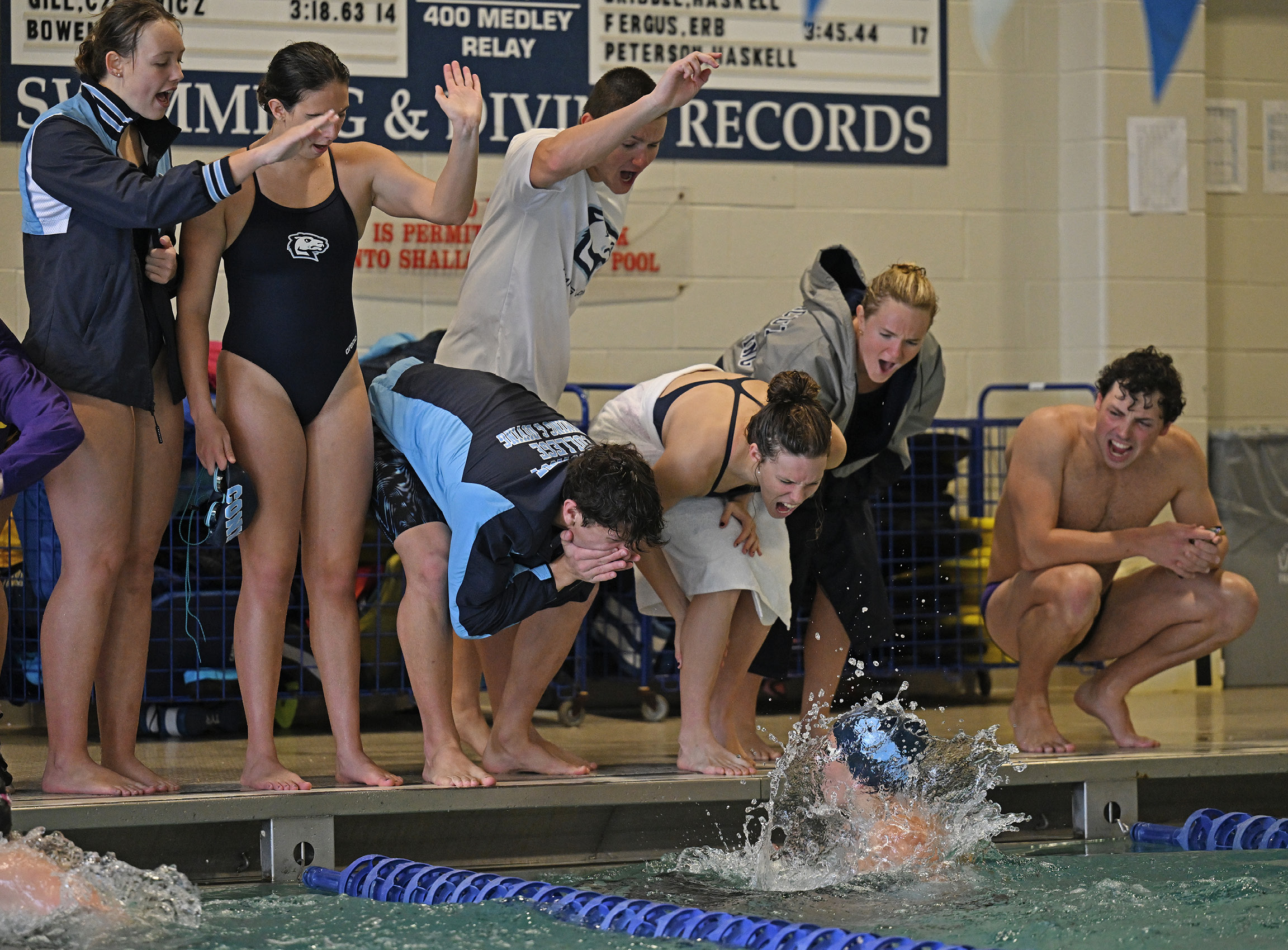 Teammates cheer on Emma Lent ’27 as she competes in the 200 yard breaststroke
