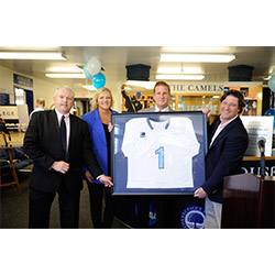 In addition to having the lacrosse locker rooms named in their honor, Karen and Rob Hale '88 (center) received a varsity lacrosse jersey from Fran Shields (left), the Katherine Wenk Christoffers ’45 Director of Athletics, and Dave Cornell, head coach of the men's lacrosse team.
